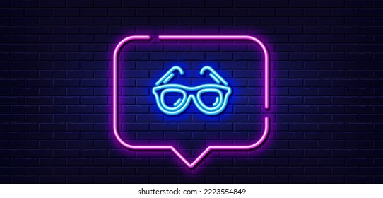Neon light speech bubble. Travel sunglasses line icon. Trip sun glasses sign. Holidays symbol. Neon light background. Sunglasses glow line. Brick wall banner. Vector