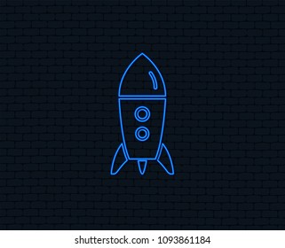 Neon light. Start up icon. Startup business rocket sign. Glowing graphic design. Brick wall. Vector