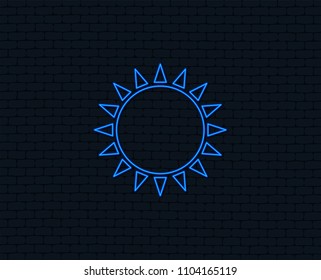 Neon light. Sun icon. Sunlight summer symbol. Hot weather sign. Glowing graphic design. Brick wall. Vector