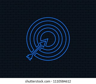 Neon light. Target aim sign icon. Darts board with arrow symbol. Glowing graphic design. Brick wall. Vector