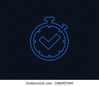 Neon light. Timer sign icon. Check stopwatch symbol. Glowing graphic design. Brick wall. Vector