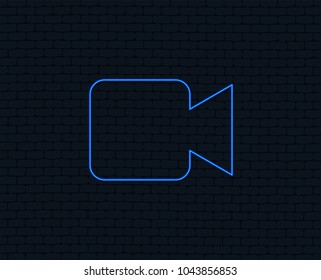 Neon light. Video camera sign icon. Video content button. Glowing graphic design. Brick wall. Vector