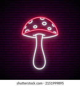 Neon mushroom fly agaric. Glowing signboard of poisonous mushroom on brick wall background. Be careful not to eat - poisonous food.