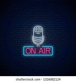 Neon on the air sign with microphone on dark brick wall background. Glowing signboard of radio station. Sound cafe icon. Music show poster. Vector illustration.