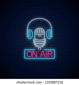 Neon on the air sign with microphone and headphones on dark brick wall background. Glowing signboard of radio station. Sound cafe icon. Music show poster. Vector illustration.