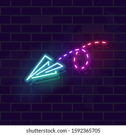Neon paper plane icon with trail. Nice and cute airplane travel or internet message symbol. Fluorescent line image on brick wall background. Square size for social network post.