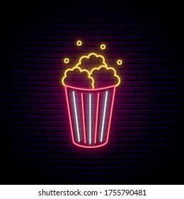 Neon Popcorn sign. Bright glowing popcorn icon on dark brick background. Vector illustration.