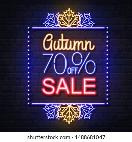 Neon sign autumn big sale with maple leaves on brick background. Vintage electric signboard.