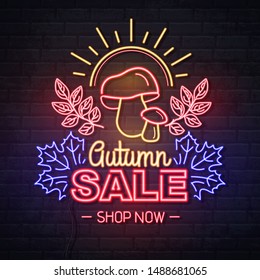 Neon sign autumn big sale with mushrooms on brick background. Vintage electric signboard.