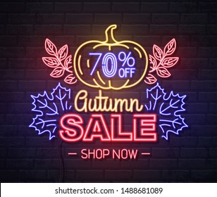 Neon sign autumn big sale with pumpkin on brick background. Vintage electric signboard.