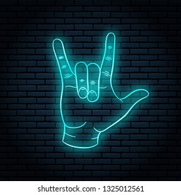 Neon sign with blue glow. Hand gesture, rock n roll. On a brick wall background, for your design.