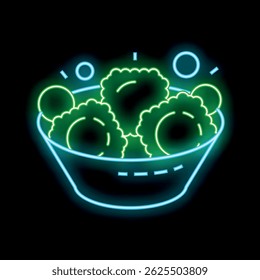 Neon sign of a bowl overflowing with balls of green cookie dough on a black background