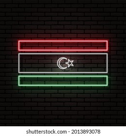 Señal de neón en forma de bandera de Libia. En el fondo de una pared de ladrillo con una sombra. Para el diseño de temas turísticos o patrióticos. El continente africano