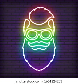 A neon sign in the form of a hipster with a beard, glasses. Shimmering all the colors of the rainbow. Against the background of a brick wall, with a shadow.