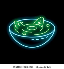 Neon sign showing green soup with leaves in a bowl on a black background
