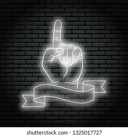 Neon sign with white glow. Hand gesture, shows index finger up. On a brick wall background, for your design. With ribbon, flag for text.