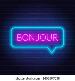 Neon sign of word bonjour in speech bubble frame on dark background. Greetings in French. Light banner on the wall background.
