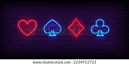 Neon signs set of Suits of playing cards. Card suits, Poker, Blackjack neon icons. Glowing casino signboard. Aces Playing Cards symbols with Glowing Neon Lights on brick wall background