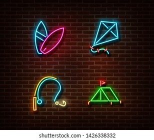 Neon surf boards, kite, fishing rod, tent signs vector isolated on brick wall. Vacation light symbol, decoration effect. Neon  illustration.