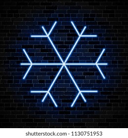 neon symbol of snowflake on dark brick wall background. simple weather icon