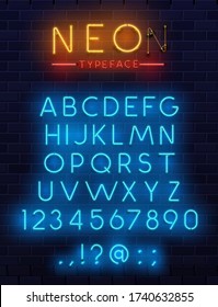 Neon type font, glowing vector alphabet letters, digits and punctuation marks on dark brick wall background. Blue and orange neon glow abc uppercase characters, fluorescent electric retro style font