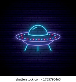 Neon UFO sign. Bright glowing spaceship icon on dark brick background. Vector illustration.