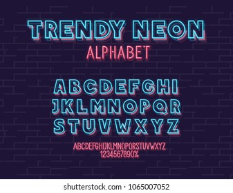 Neon vector font set isolated on brick wall background. For logo, poster, banner. Headline and small condensed uppercase letters.