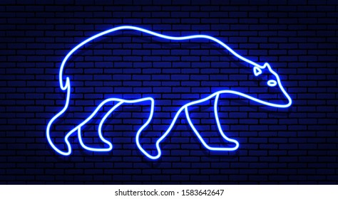 Neon winter sign. The contour of the white polar bear in shades of blue. Against a brick wall, with a shadow.