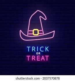 Neon witch hat icon. Trick or treat phrase. Happy Halloween concept. Night bright signboard. Outer glowing effect banner. Editable stroke. Isolated vector stock illustration