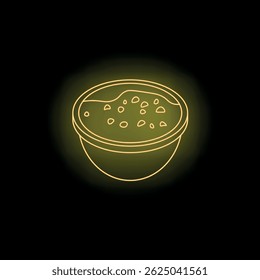 Neon yellow lentil soup is served in a bowl on a dark background