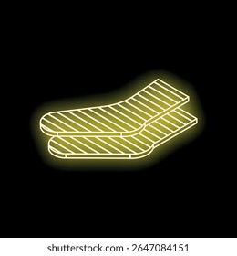 Neon yellow striped socks glowing on black background representing winter clothing, warmth, and comfort