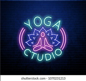 neon yoga sign isolated on brick wall