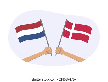 The Netherlands and Denmark flags. Dutch and Danish national symbols. Hand holding waving flag. Vector illustration.