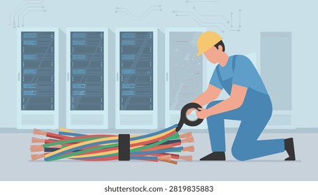 Network technician kneeling down to bundle and wrap colorful cables with electrical tape.