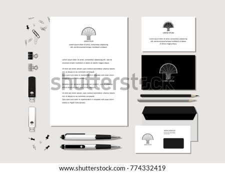 The neutral black-and-white corporate identity with the stylized tree. Samples of business cards, a flash card, a pen, an envelope. Vector.