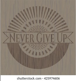 Never Give Up badge with wooden background