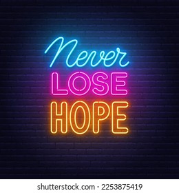 Never Lose Hope neon quote on brick wall background.