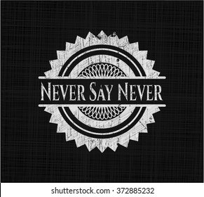 Never Say Never chalkboard emblem written on a blackboard