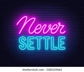 Never Settle l neon quote on a brick wall.