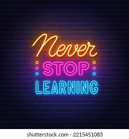 Never Stop Learning neon quote on a brick wall.