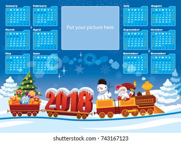 New Calendar 2018 and Santa Claus in a toy train with gifts, snowman and Christmas tree.
