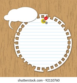 New circle pad with pin on wooden board.