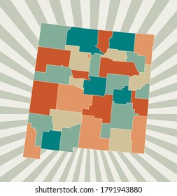 New Mexico map. Poster with map of the US state in retro color palette. Shape of New Mexico with sunburst rays background. Vector illustration.