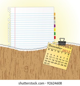 New paper sheet in rip wood folder and hold  2012 calendar December by paper clip.