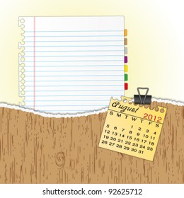 New paper sheet in rip wood folder and hold  2012 calendar August by paper clip.