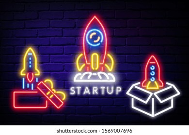 New startup neon text with rocket and bitcoin sign. Business and technology concept. Advertisement design. Night bright neon sign, colorful billboard, light banner. Vector illustration in neon style.