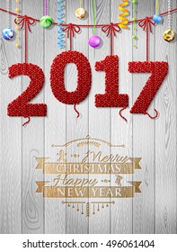 New Year 2017 knitted fabric as christmas decoration. Holiday congratulation against wood background