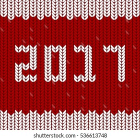 New Year 2017 on red fabric. Fragments of knitting in shape of number 2017. Knitting Pattern