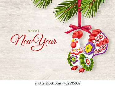 New Year 2017 Rooster. Chinese New Year. Happy New Year greeting card. New Year background and place for your text. Christmas tree toy. Wooden background with fir branches. Christmas decoration.