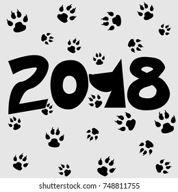 New year 2018, the year of the dog, on the gray background the dog tracks.